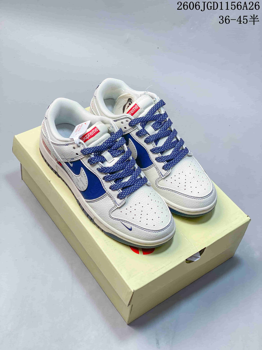 Several white low-top sneakers with blue or gray accents and patterned panels shown from above.