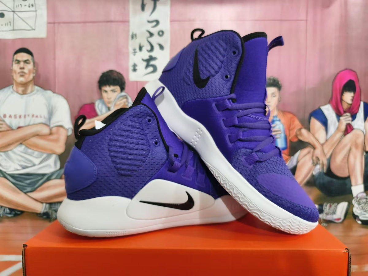 Pair of purple Nike high-top basketball shoes shown at an angle