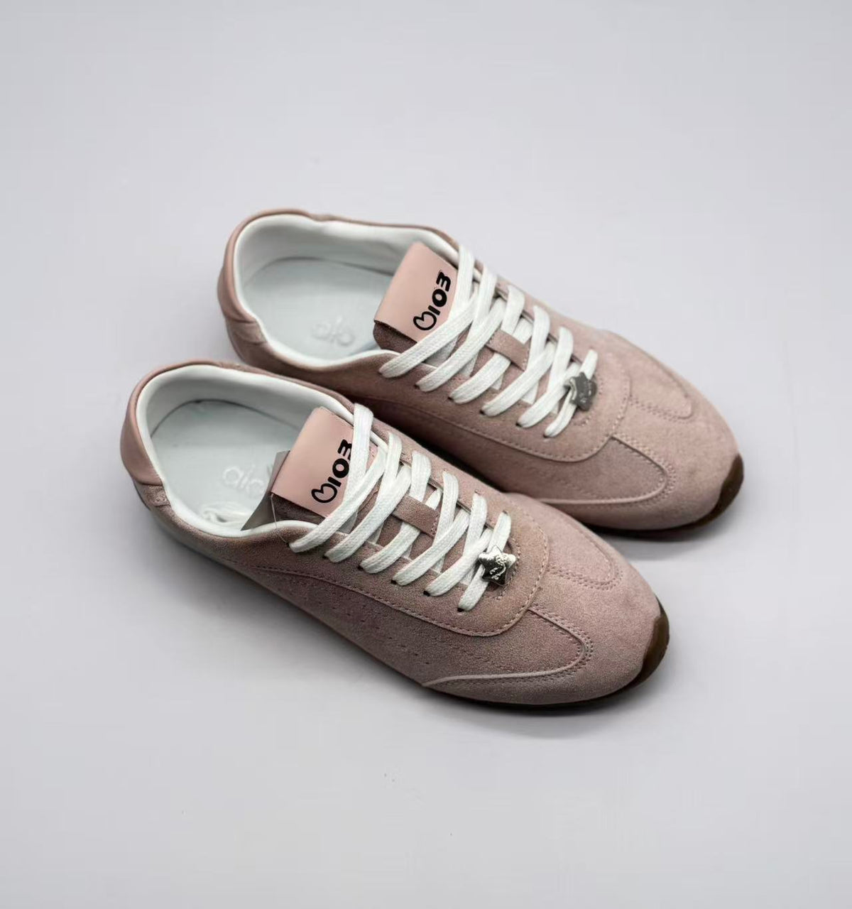 Top three-quarter view of the pair showing the lacing layout and branded tongues.