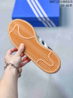 Close-up of the sneaker outsole showing a gum-colored rubber tread with a repeating zigzag pattern.