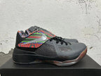 Side view showing the multicolor patterned panel, dark mesh-like section, and black midsole.