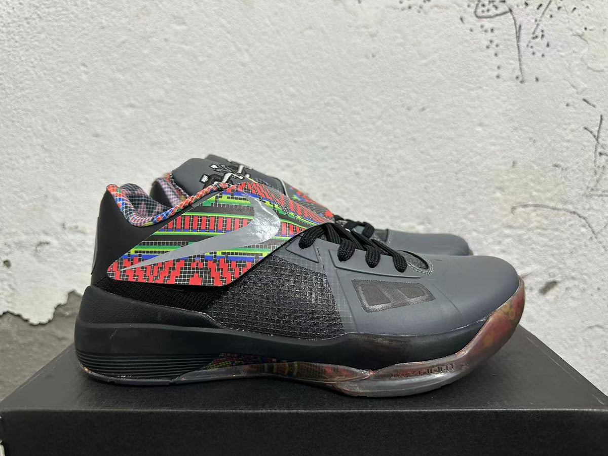 Side view showing the multicolor patterned panel, dark mesh-like section, and black midsole.
