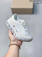 All-white On Cloudstratus 3 kids running shoe with matching laces and outsole.