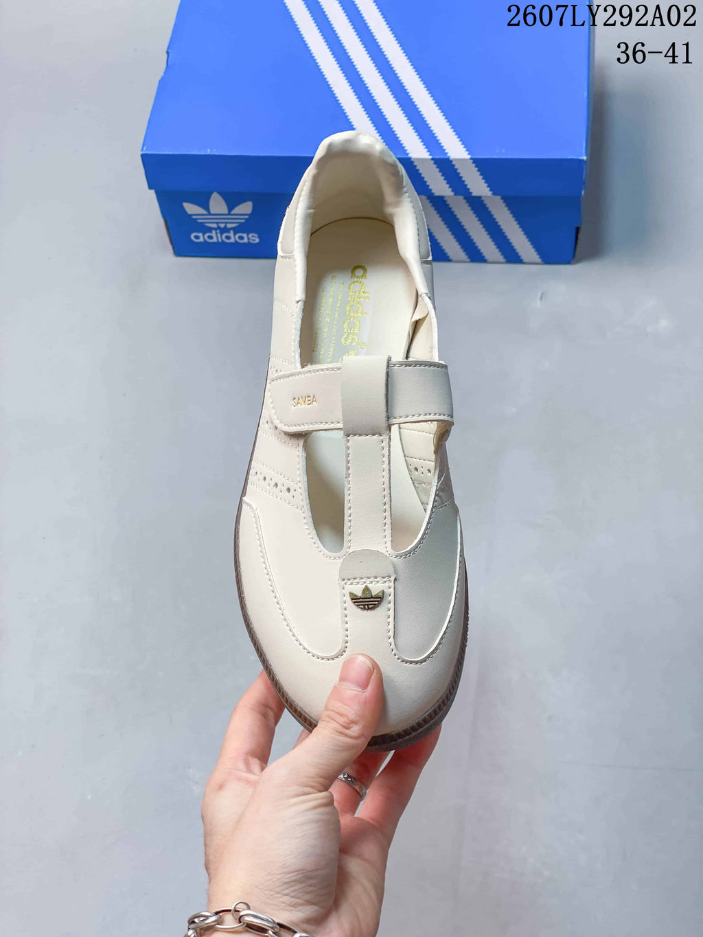 Top view of the cream Mary Jane-style sneaker showing crossover straps, Samba branding, and a small trefoil detail.
