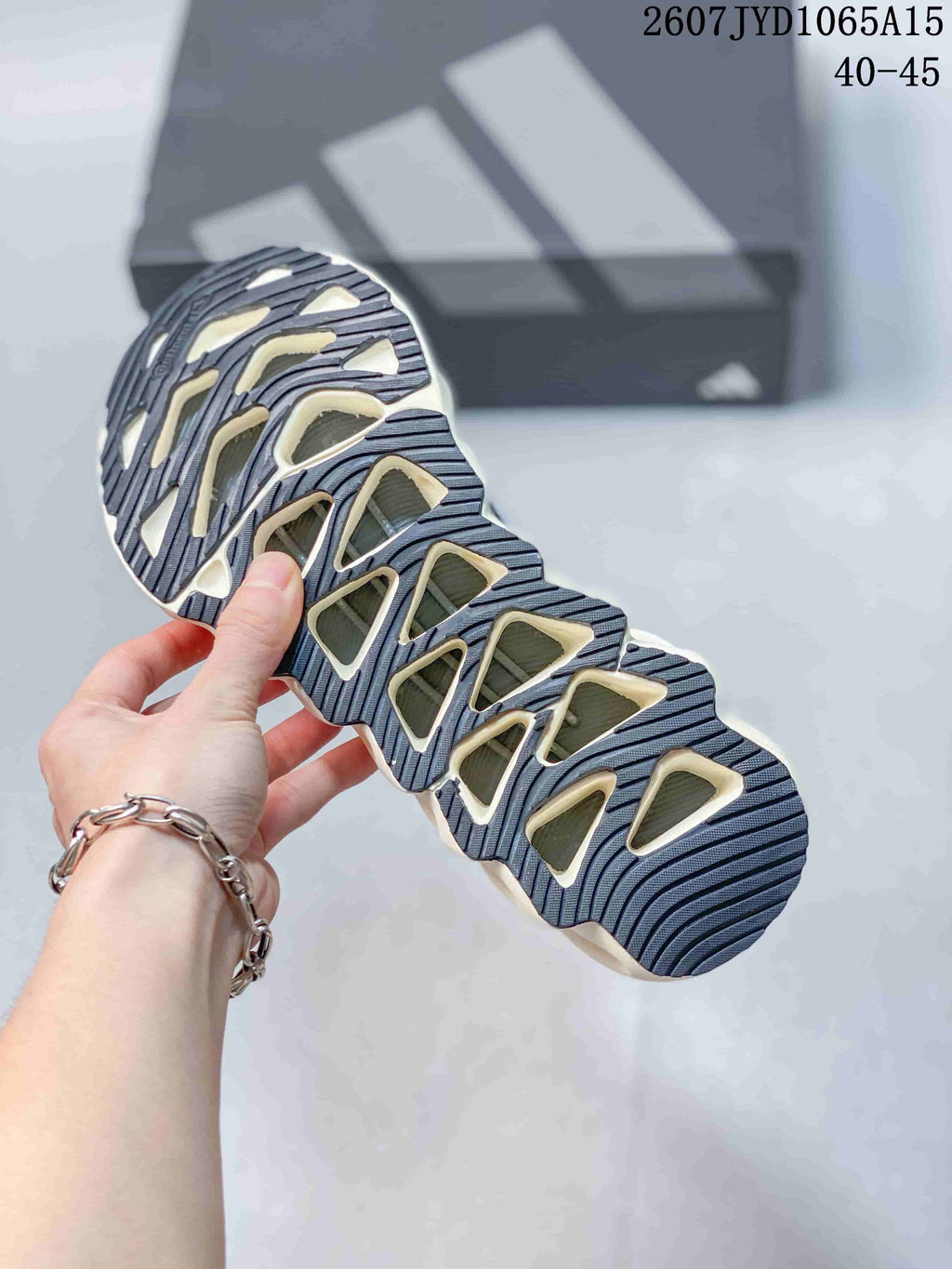 Close view of the segmented rubber outsole showing dark tread channels and light-colored cutout sections.