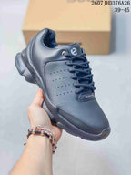 Angled front-side view of the black ECCO BIOM sneaker showing the lace-up closure, perforated side panel, padded collar, and textured outsole.
