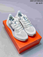 Pair of white Nike Air Zoom Pegasus 41 sneakers displayed on an orange shoebox.