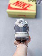 Rear view of the white and gray low-top sneaker showing the padded heel collar and Air branding.