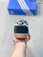 Rear view showing the black heel, white heel detail, and trefoil branding.