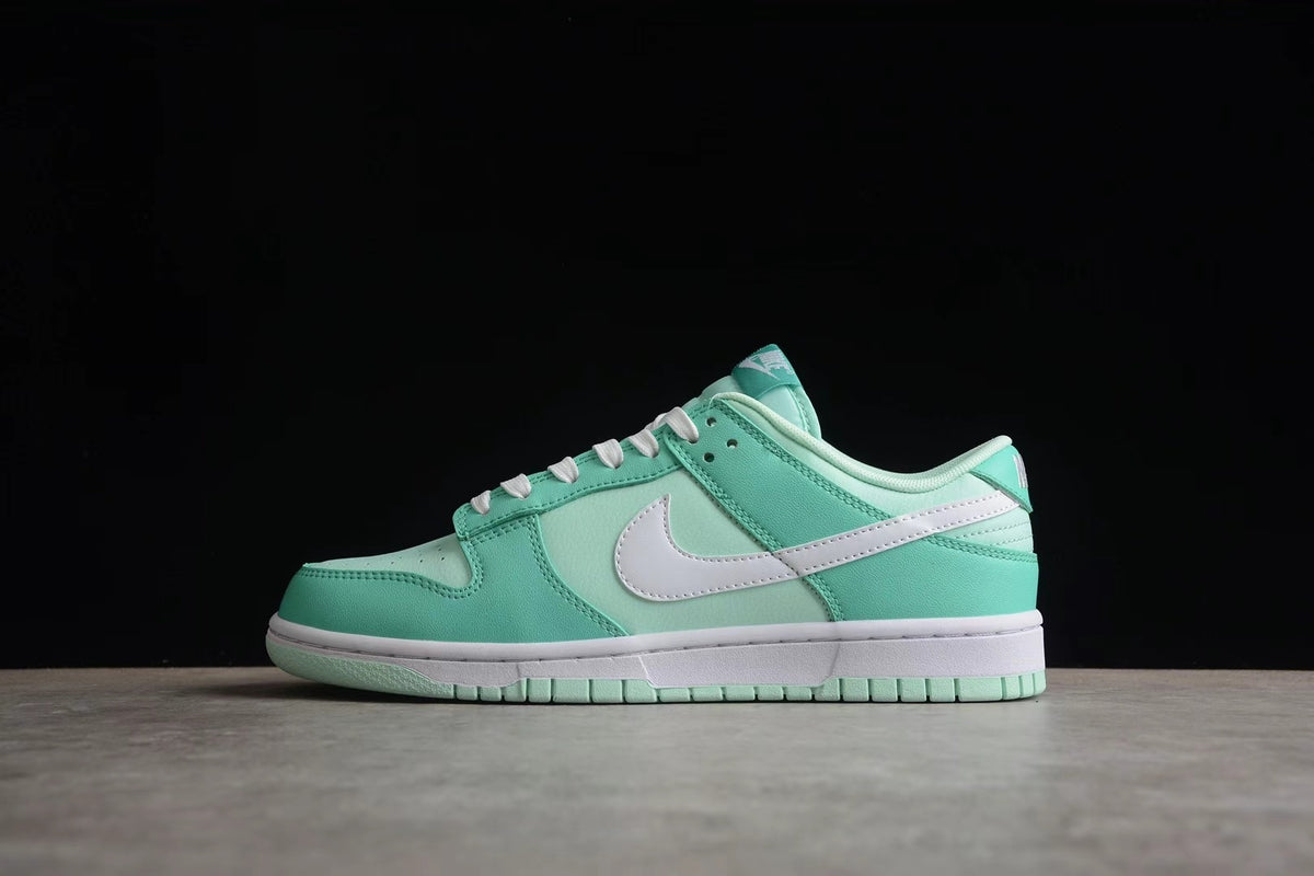 Opposite side profile showing the low-top silhouette, white Swoosh, mint green overlays, and layered sole.