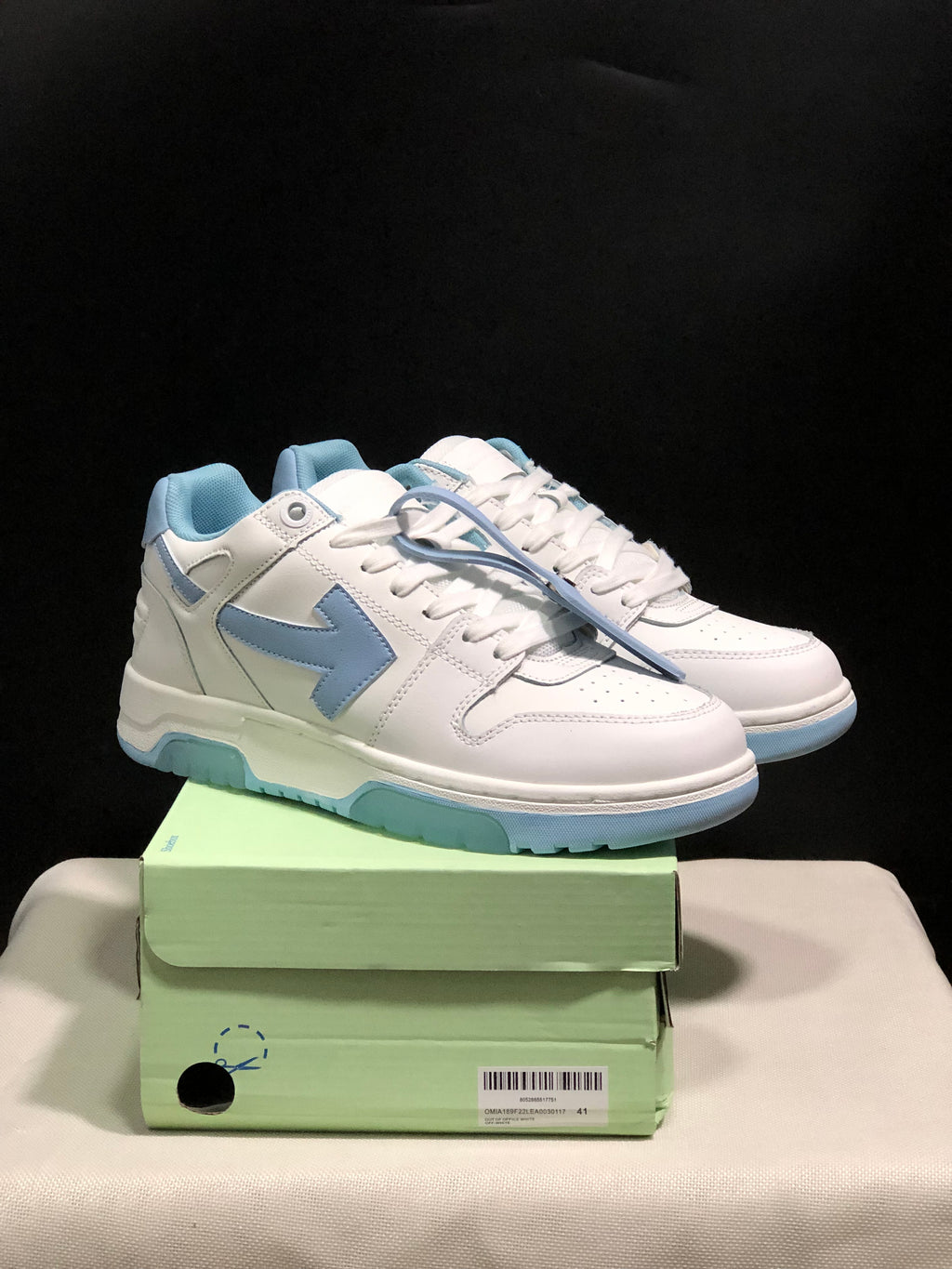 Pair of white and light blue Off-White Out Of Office low-top sneakers displayed on a green shoebox; the box label shows size 41.