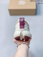 Rear view of the sneaker showing the padded heel and burgundy pull tab.