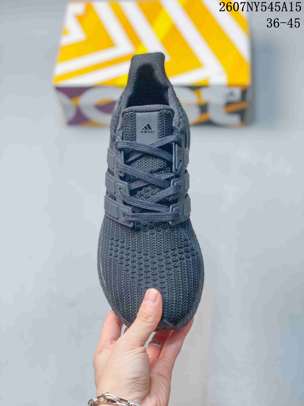 Top view of the dark gray sneaker showing the knitted toe box, laces, padded tongue, and Adidas tongue label.