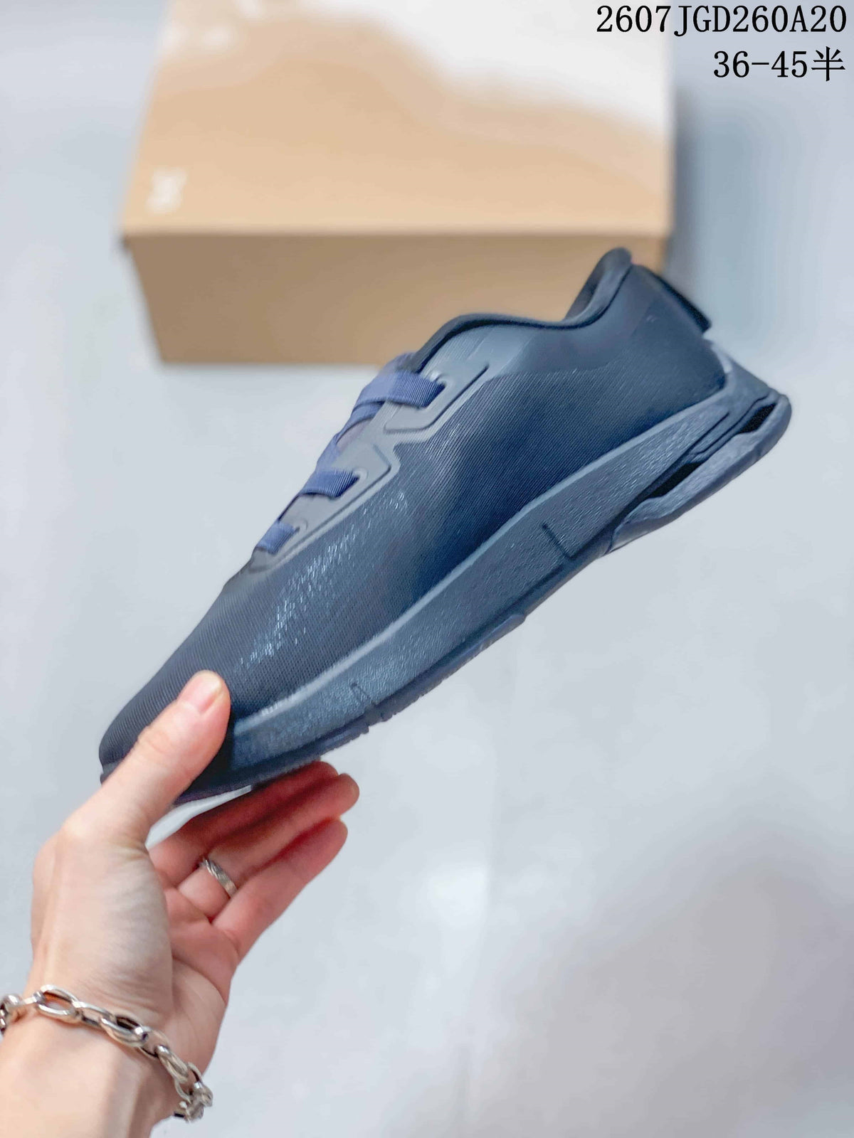 Side profile of the dark navy sneaker showing the layered upper, raised midsole and outsole tread.