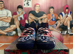 Front view of a pair of patterned high-top basketball shoes with black laces.