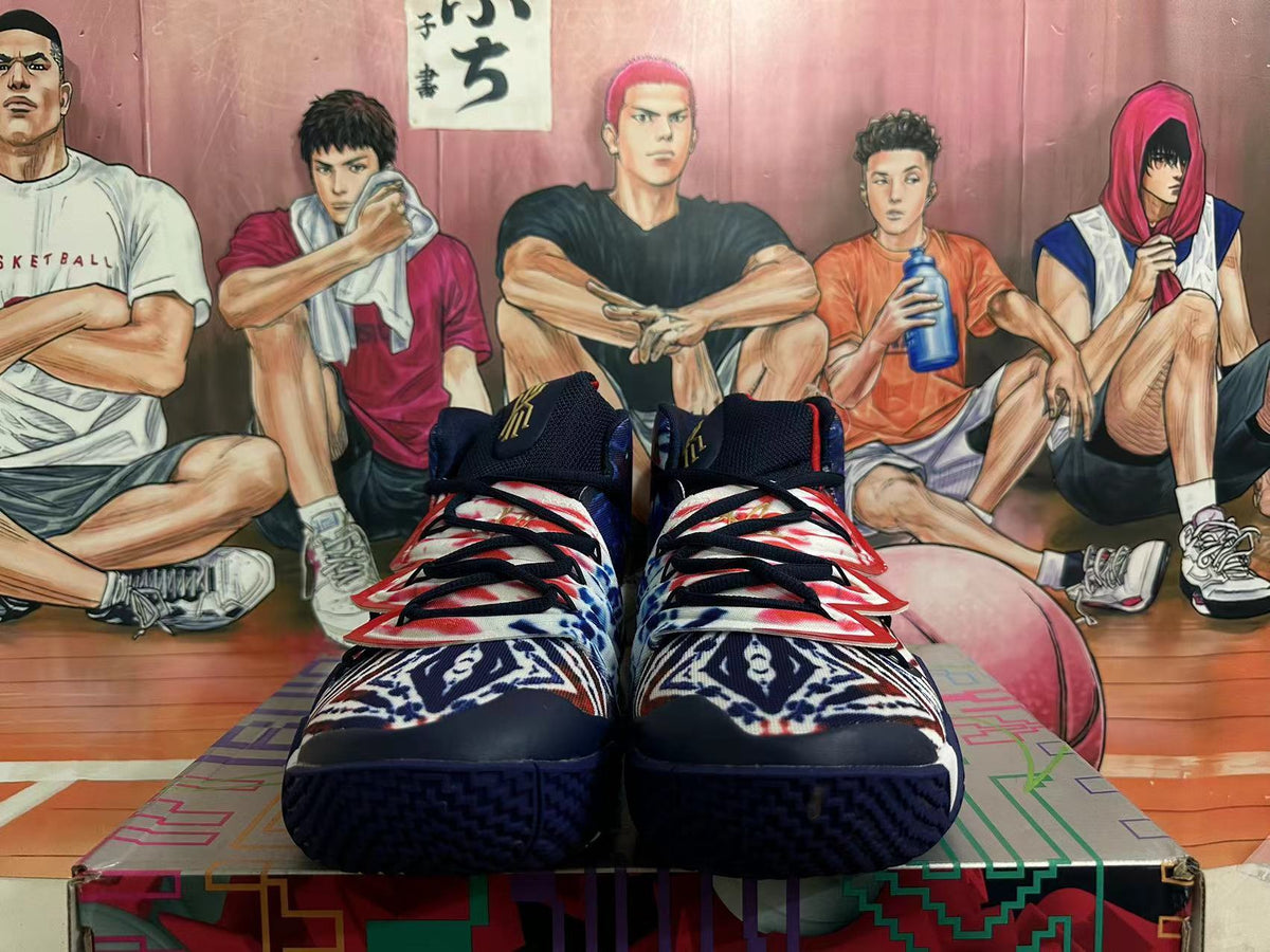 Front view of a pair of patterned high-top basketball shoes with black laces.