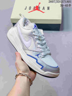Angled view of a white and silver Jordan CMFT Era sneaker with blue accents.