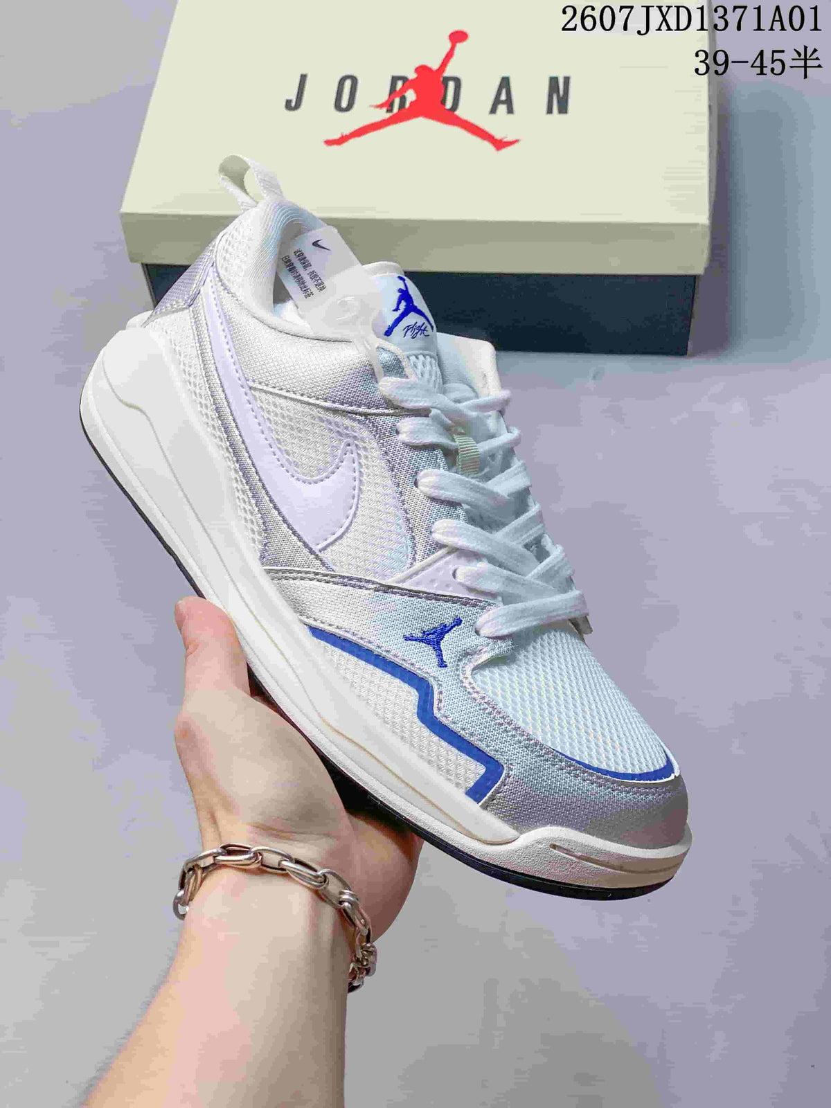 Angled view of a white and silver Jordan CMFT Era sneaker with blue accents.