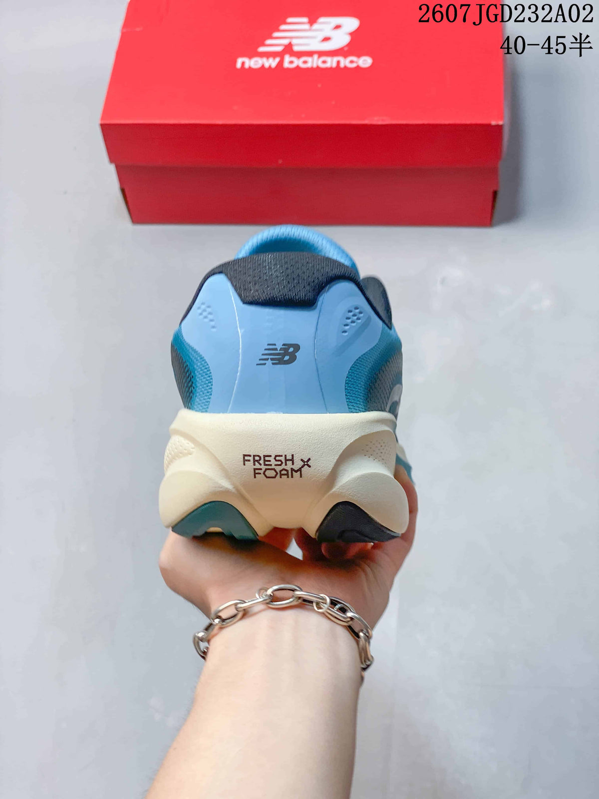 Rear view of the blue shoe showing the New Balance logo and Fresh Foam marking