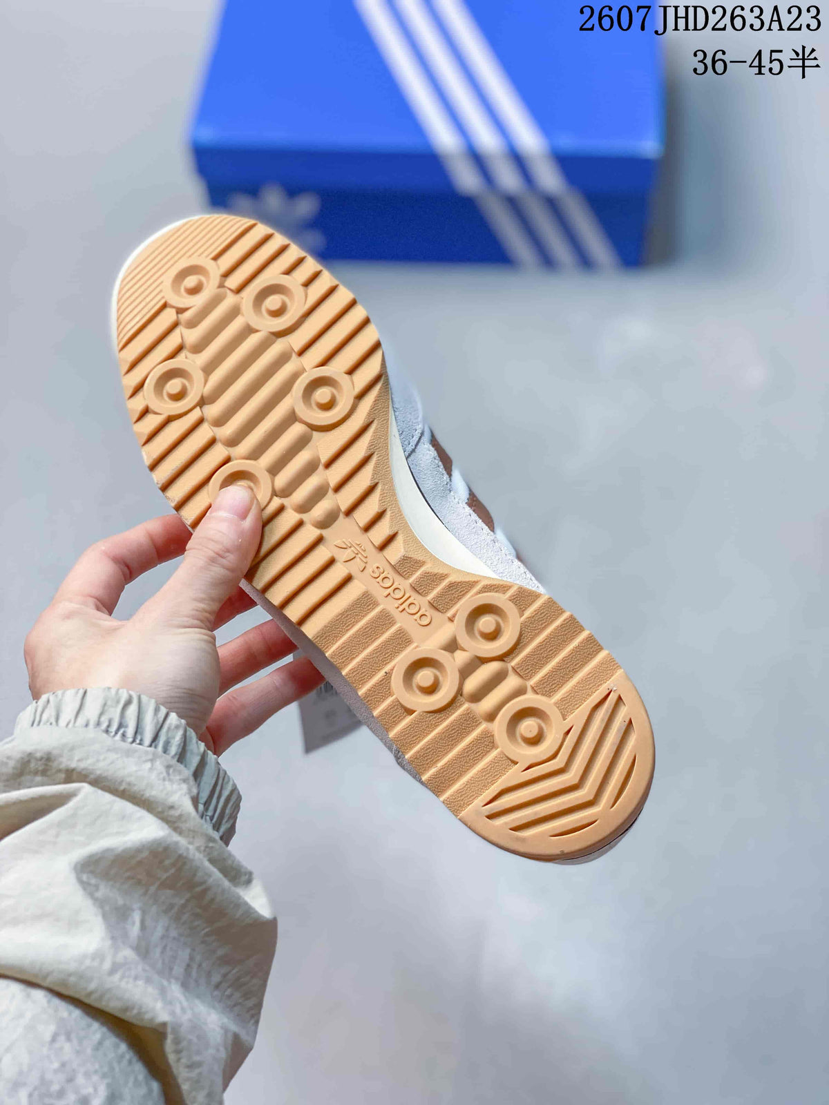 Close view of the gum-colored outsole showing its circular traction details and patterned tread.