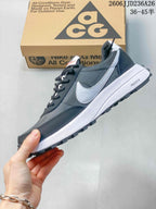 Side profile showing the white Swoosh, white midsole, dark gray upper, and black tread.