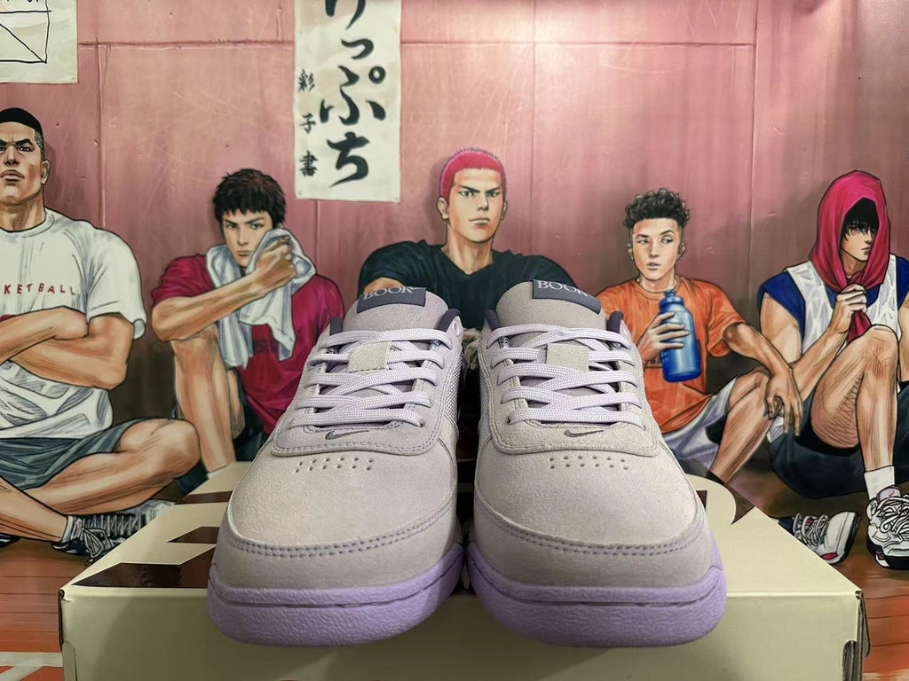 Front view of light gray-white low-top sneakers showing lace-up fastening and perforated toe panels.