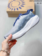 Side view showing the ASICS logo, gray upper, blue accents, and thick white midsole.