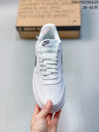 Top view of the white sneaker showing white laces, a perforated toe area, and a Nike Court Vision tongue label.