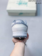 Rear view of the sneaker showing the padded collar, heel tab with Nike branding, white midsole and gray outsole.
