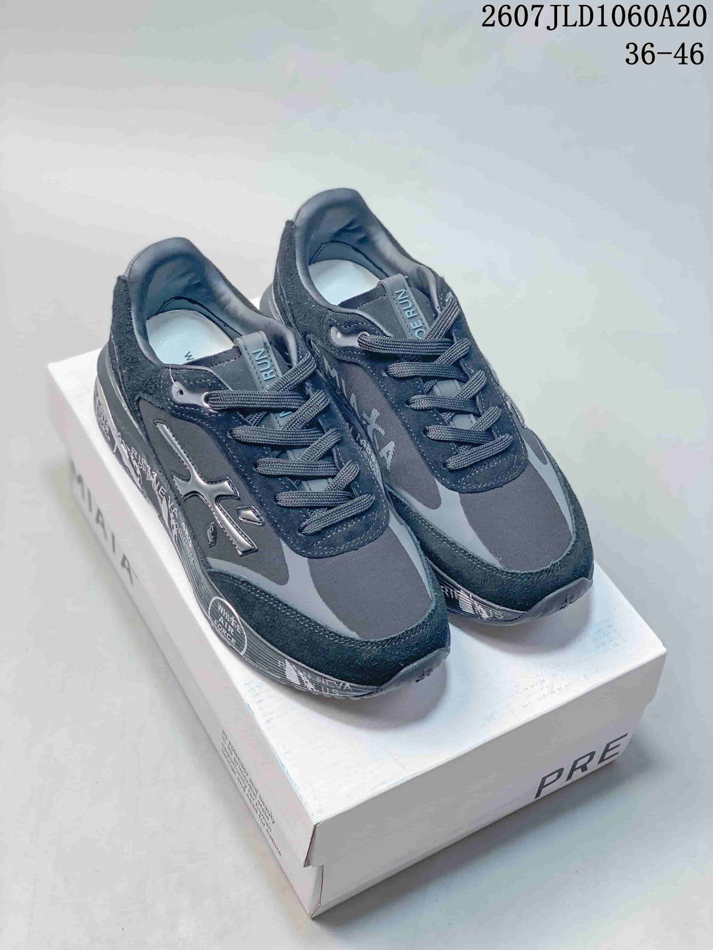Pair of black and gray Premiata Lander trainers displayed on a branded shoe box; image text shows code 2607JLD1060A20 and size range 36–46.
