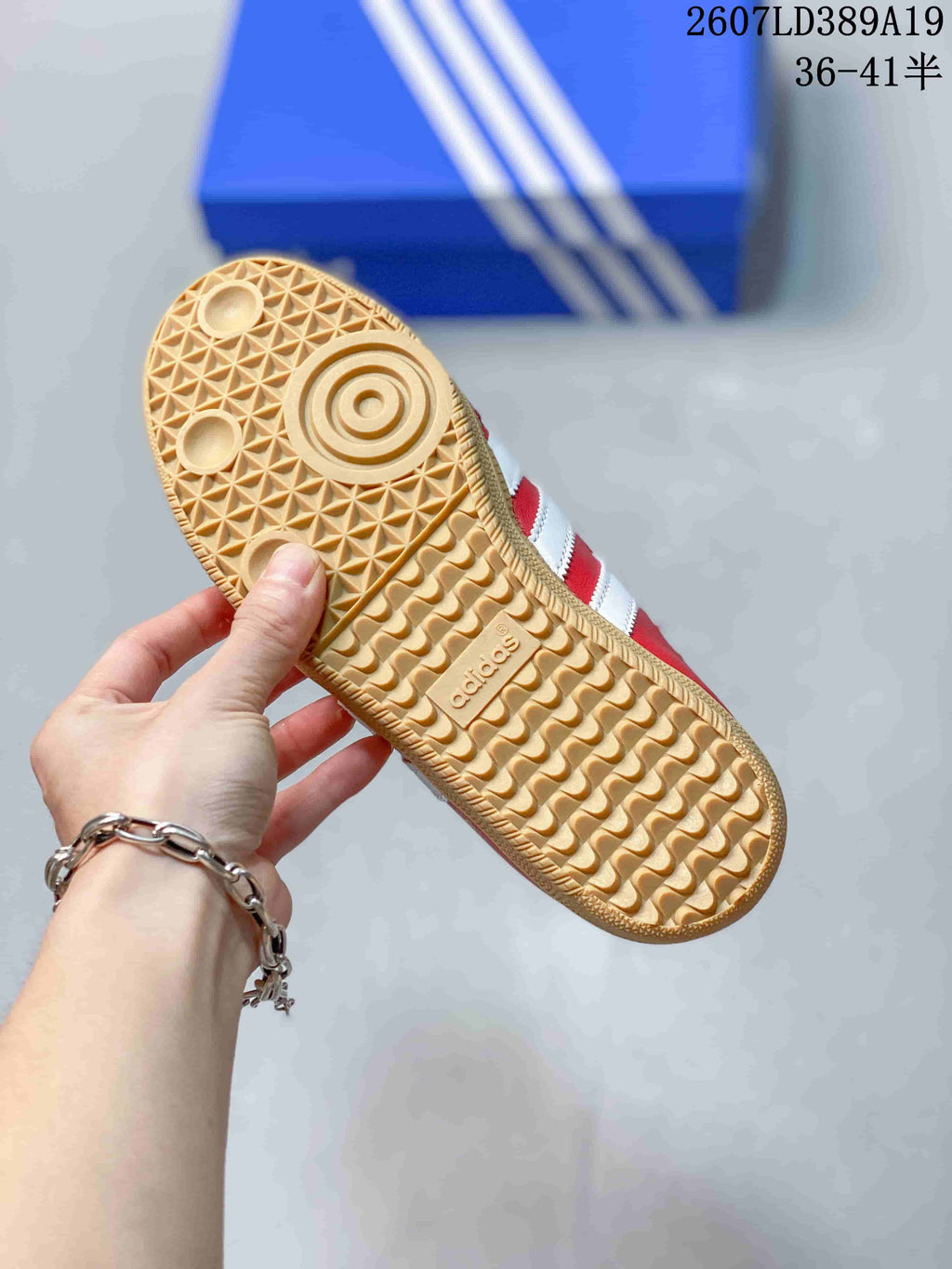 Close-up of the gum-colored outsole showing a textured geometric tread pattern and adidas branding.