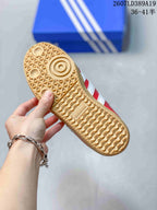 Close-up of the gum-colored outsole showing a textured geometric tread pattern and adidas branding.