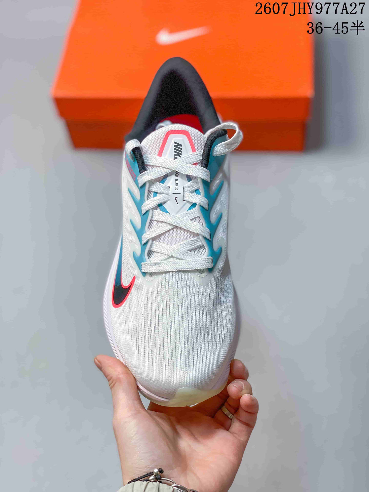 Top view showing the white mesh-style upper, laces, padded tongue, and contrasting blue and red details.