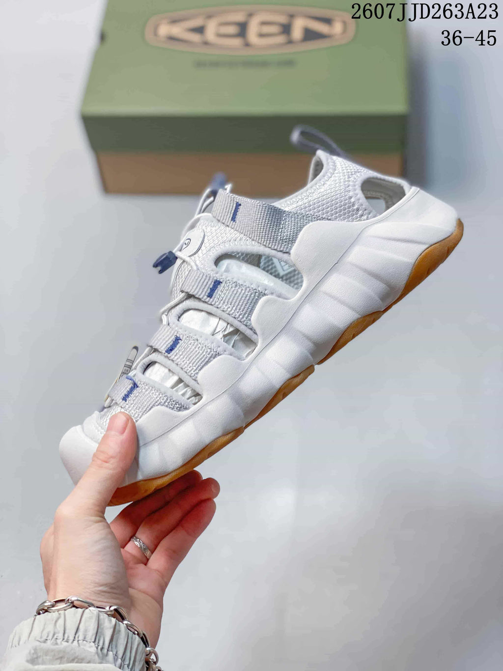 Side view highlighting the open-panel upper, quick-lace system, and thick sole.