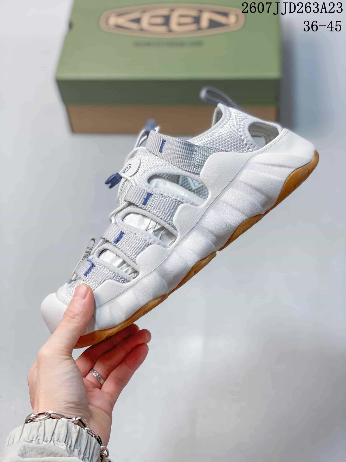 Side view highlighting the open-panel upper, quick-lace system, and thick sole.