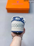 Rear view showing the blue heel collar, white heel panel and repeating monogram-style trim.