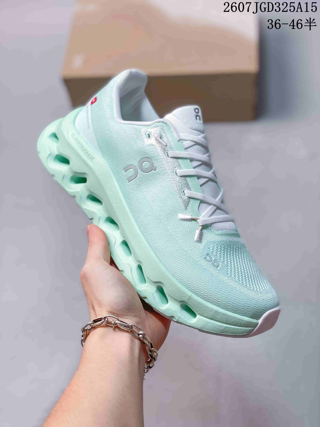 Angled side view of the mint green and white On Cloudtilt sneaker showing the mesh-like upper and sculpted sole.