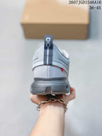 Rear view showing the padded heel, ON pull tab, gray midsole and small red-and-white heel detail.