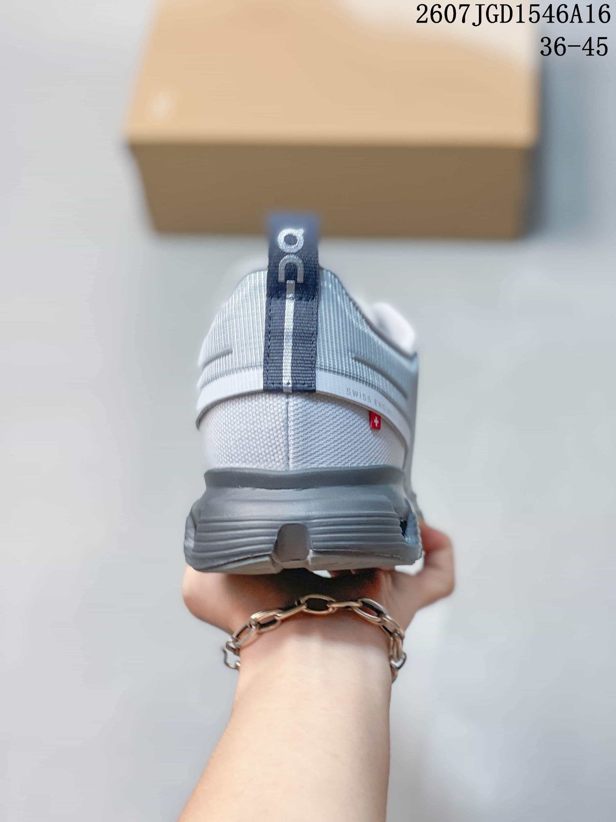 Rear view showing the padded heel, ON pull tab, gray midsole and small red-and-white heel detail.
