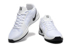 Pair of white low-top basketball shoes with black Swooshes and black outsole