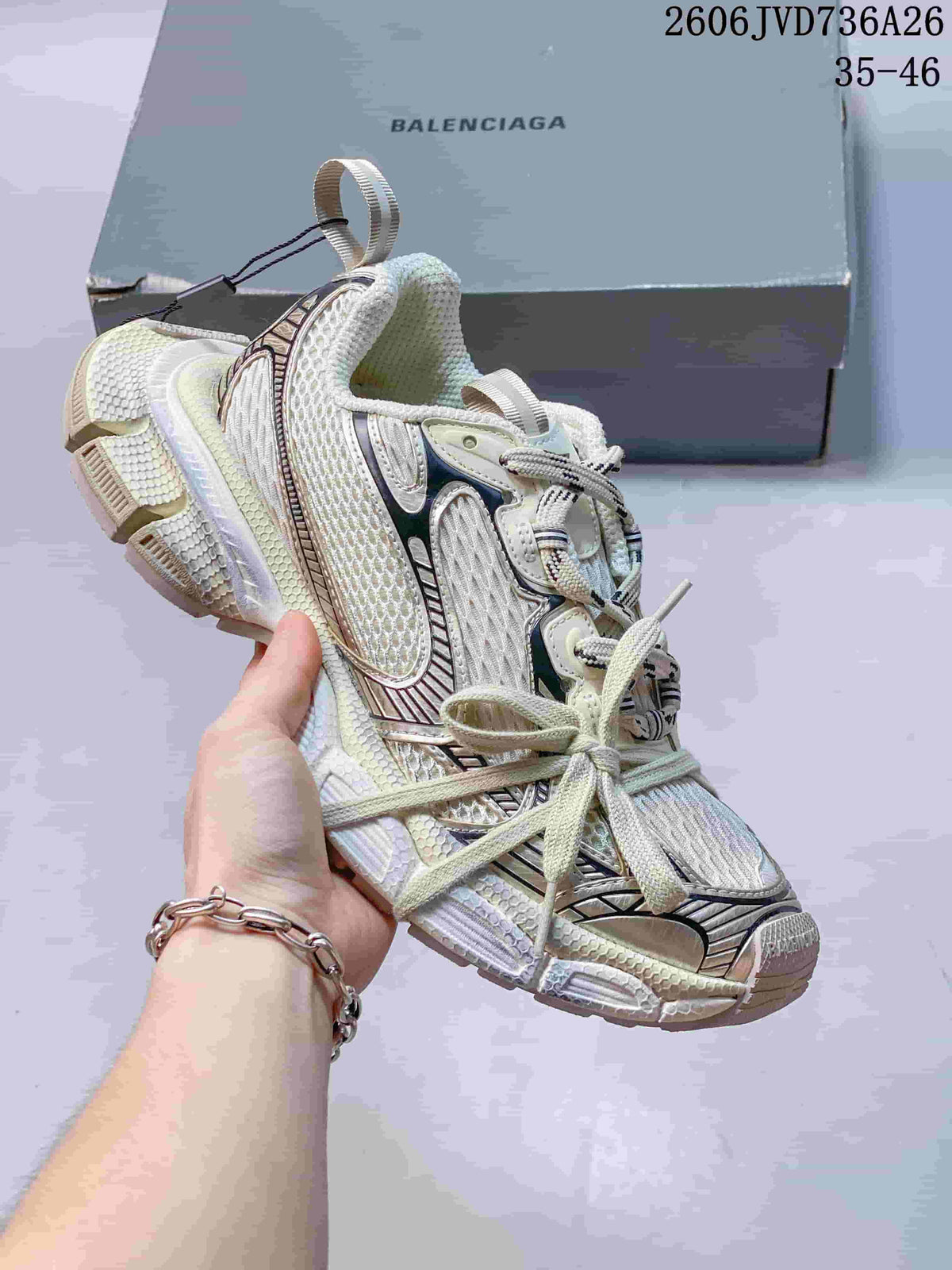 White Balenciaga 3XL-style sneaker with metallic dark accents
