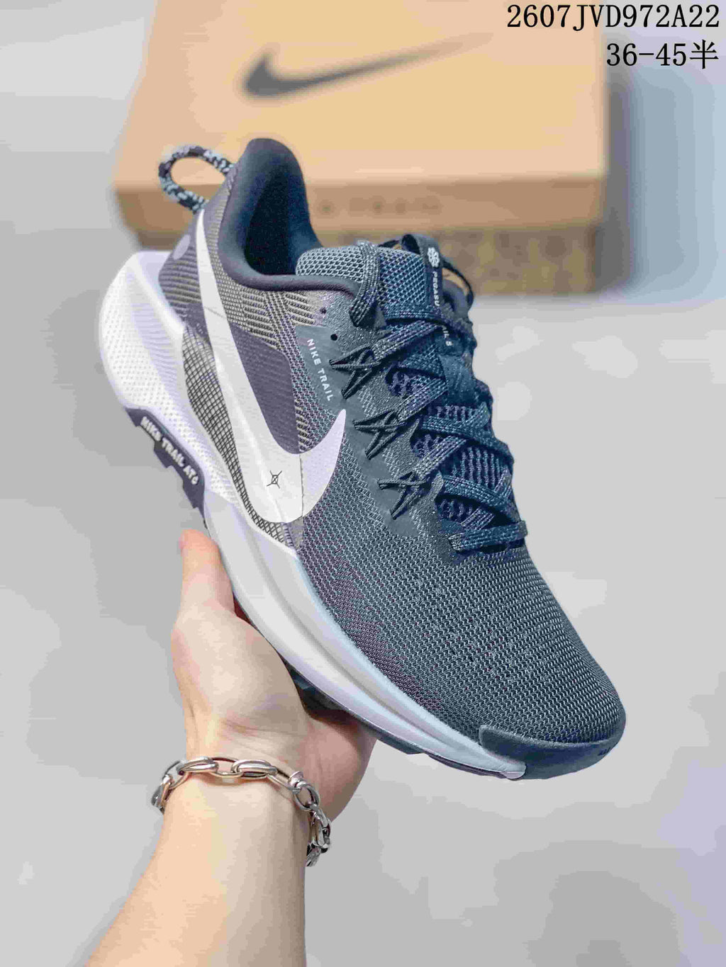 Angled side view showing the Nike Swoosh, Nike Trail branding, heel pull tab, and lugged outsole.