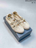 Pair of cream Onitsuka Tiger buckle-strap sneakers displayed on their shoebox.