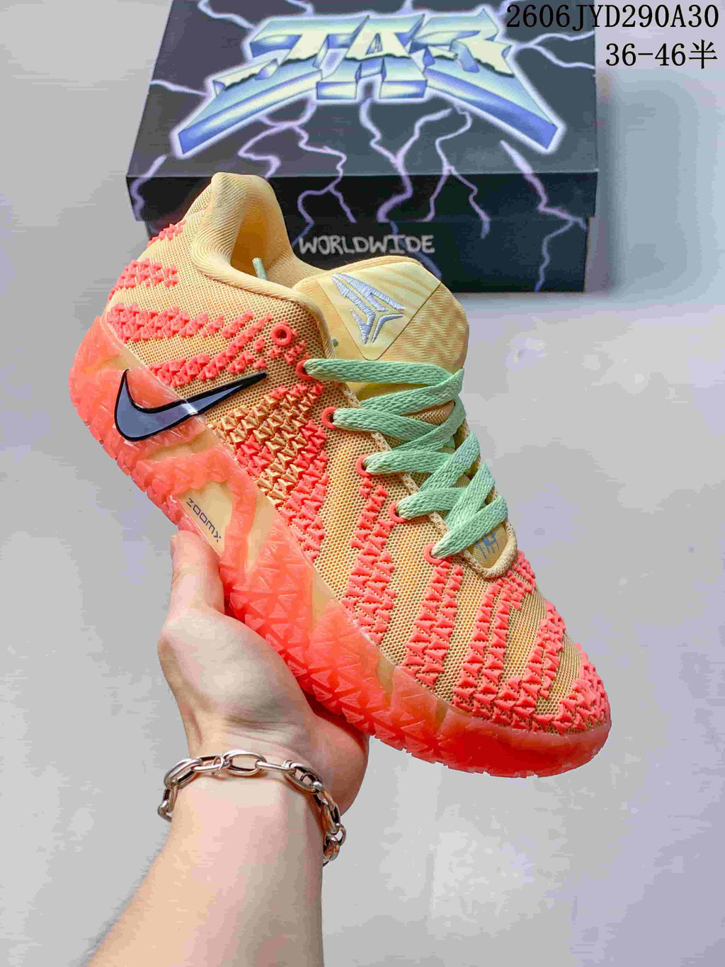 Peach and coral Nike Ja 3 basketball shoe with pale green laces