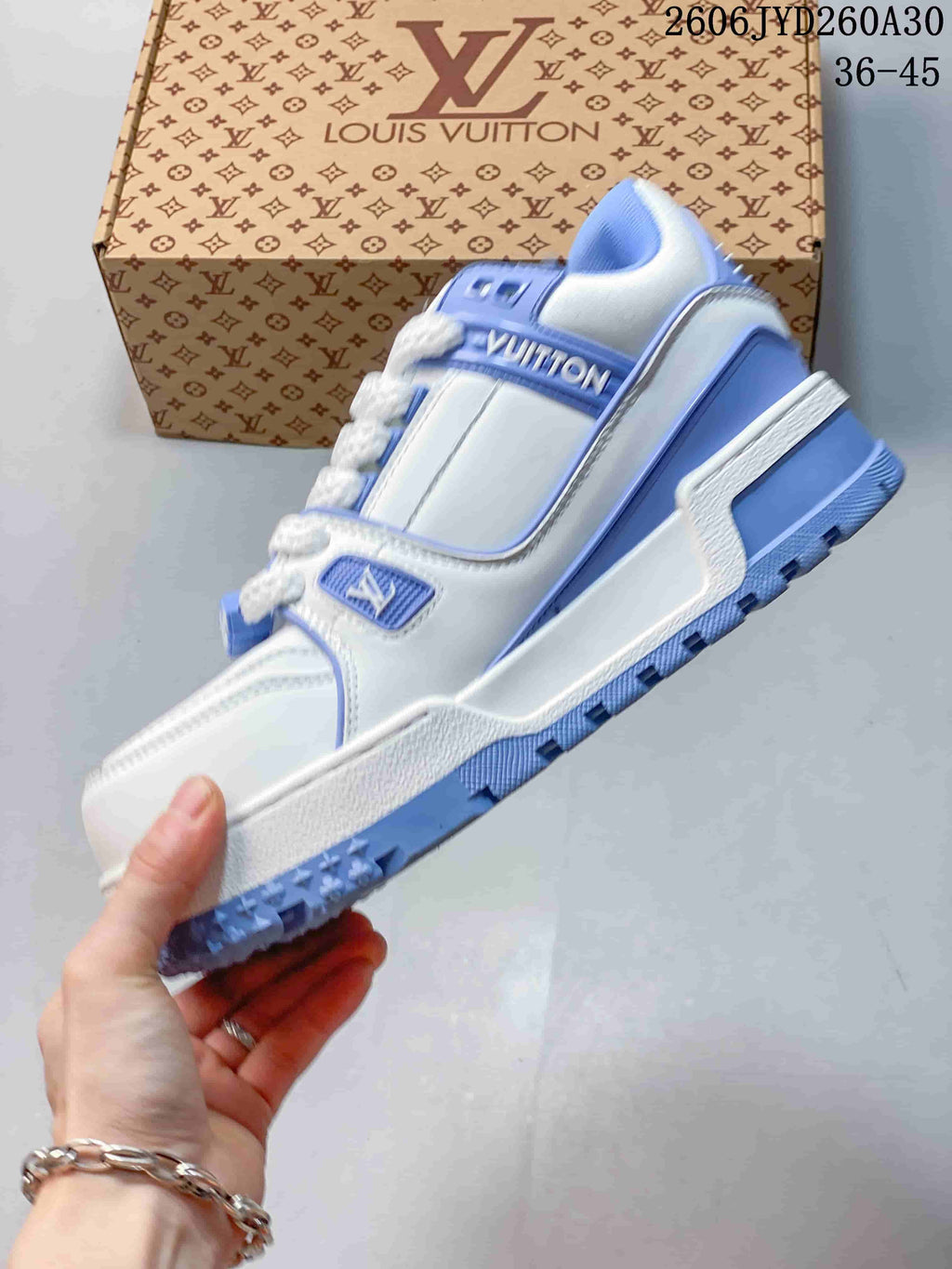 Side view of the white and blue low-top sneaker