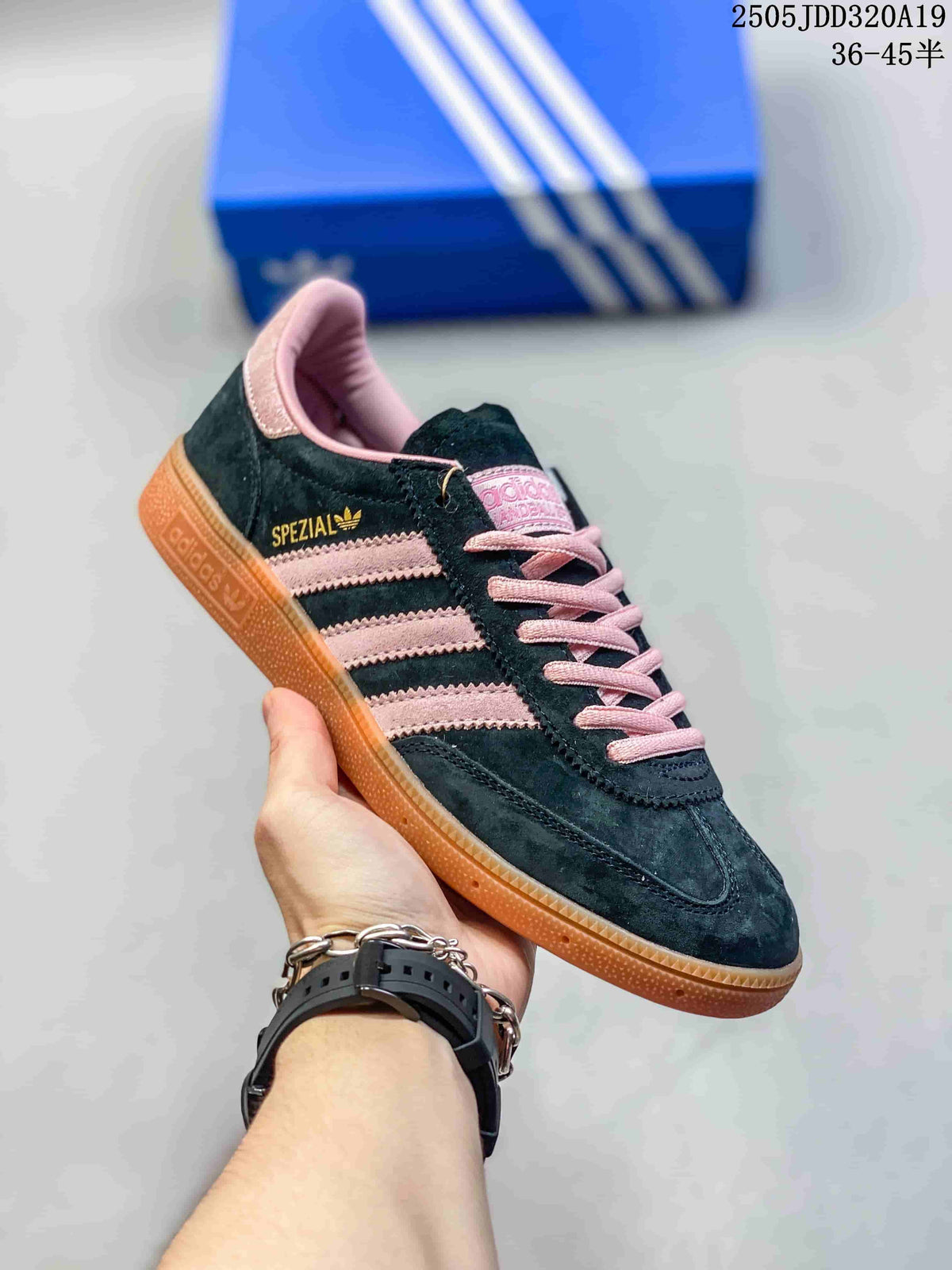 Angled side view showing the black and pink colorway, three stripes, Spezial branding, and gum outsole.