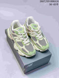 Pair of green, cream, and gray New Balance 9060 sneakers displayed on a New Balance shoebox; overlay text shows style code 2607JXD1006A16 and size range 36–45 with half sizes.