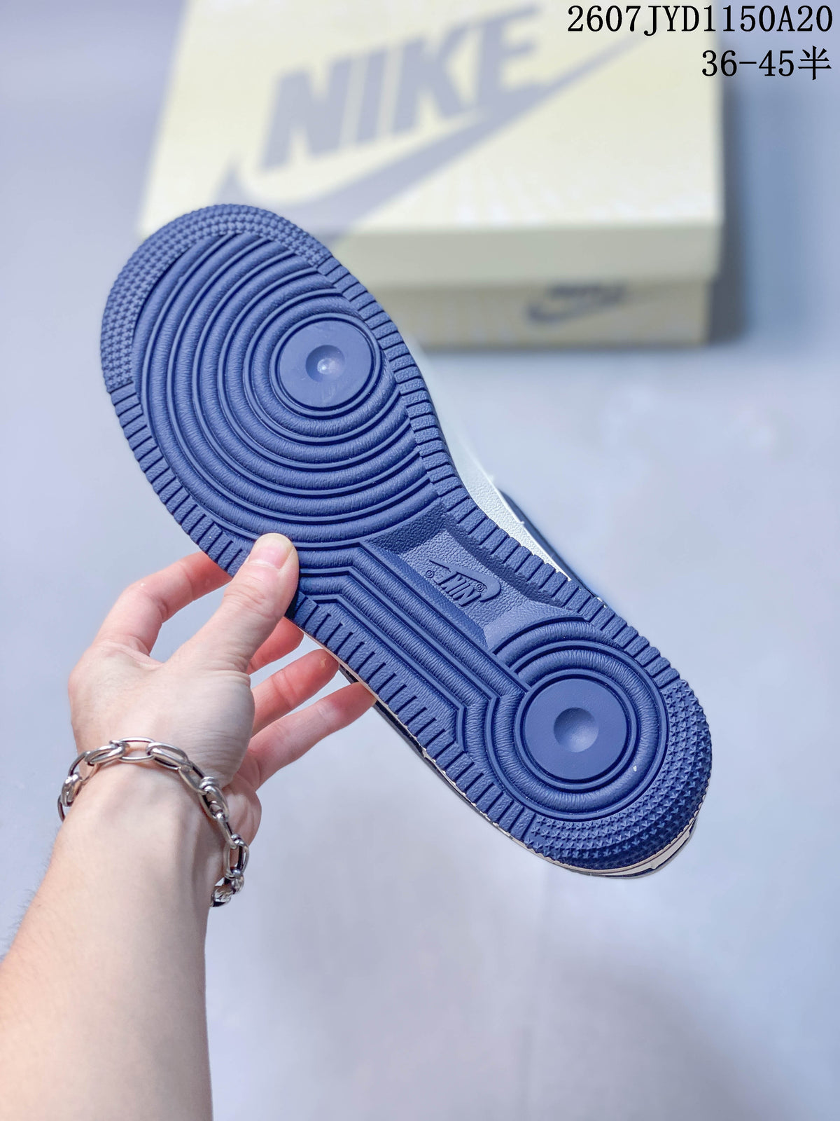 Close-up of the blue rubber outsole showing circular traction grooves.