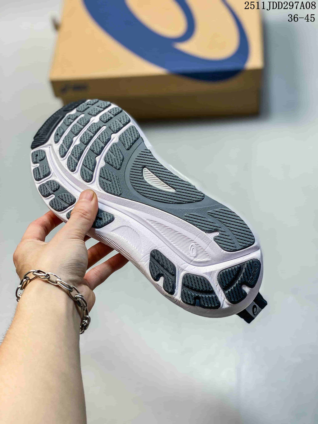 Bottom view of a navy and white ASICS sneaker showing the segmented dark outsole tread and white midsole.