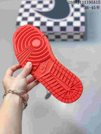 Close-up of the red rubber outsole showing circular and geometric traction patterns.